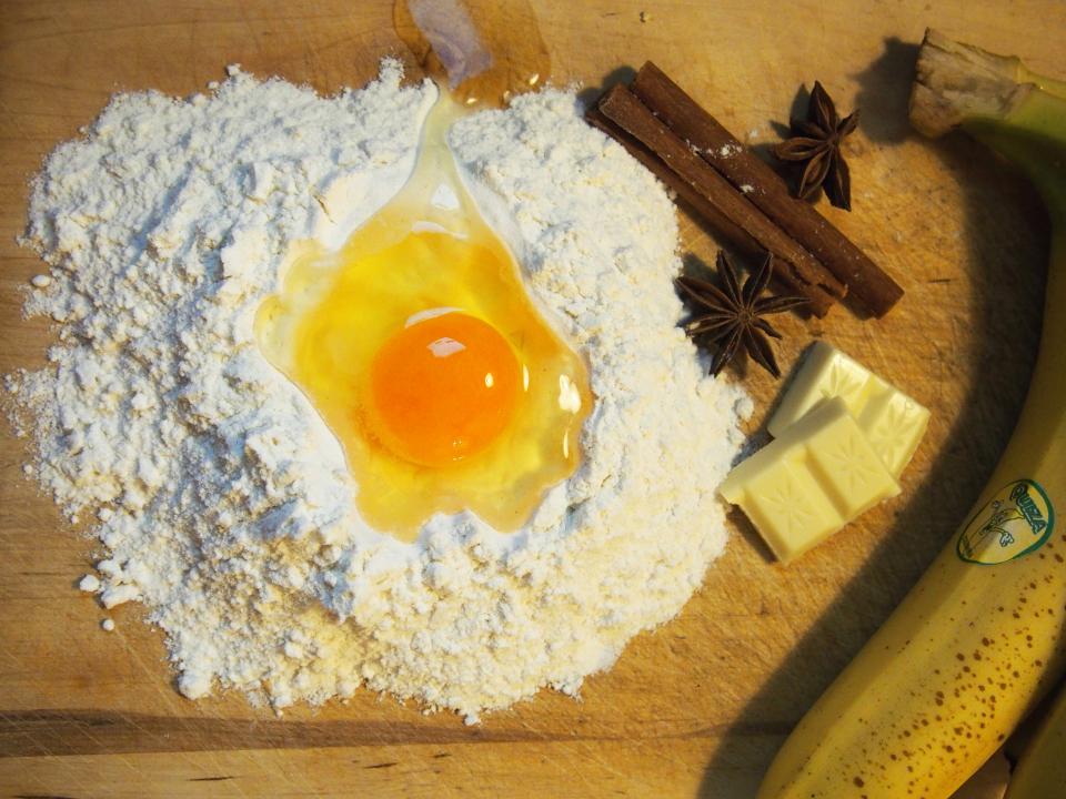 A stand mixer with cookie dough on a flour-dusted counter